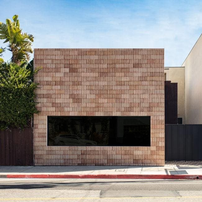 Modern residential exterior with a distinctive brick facade.