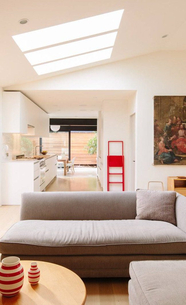 Bright modern residential living room with skylights and contemporary decor.