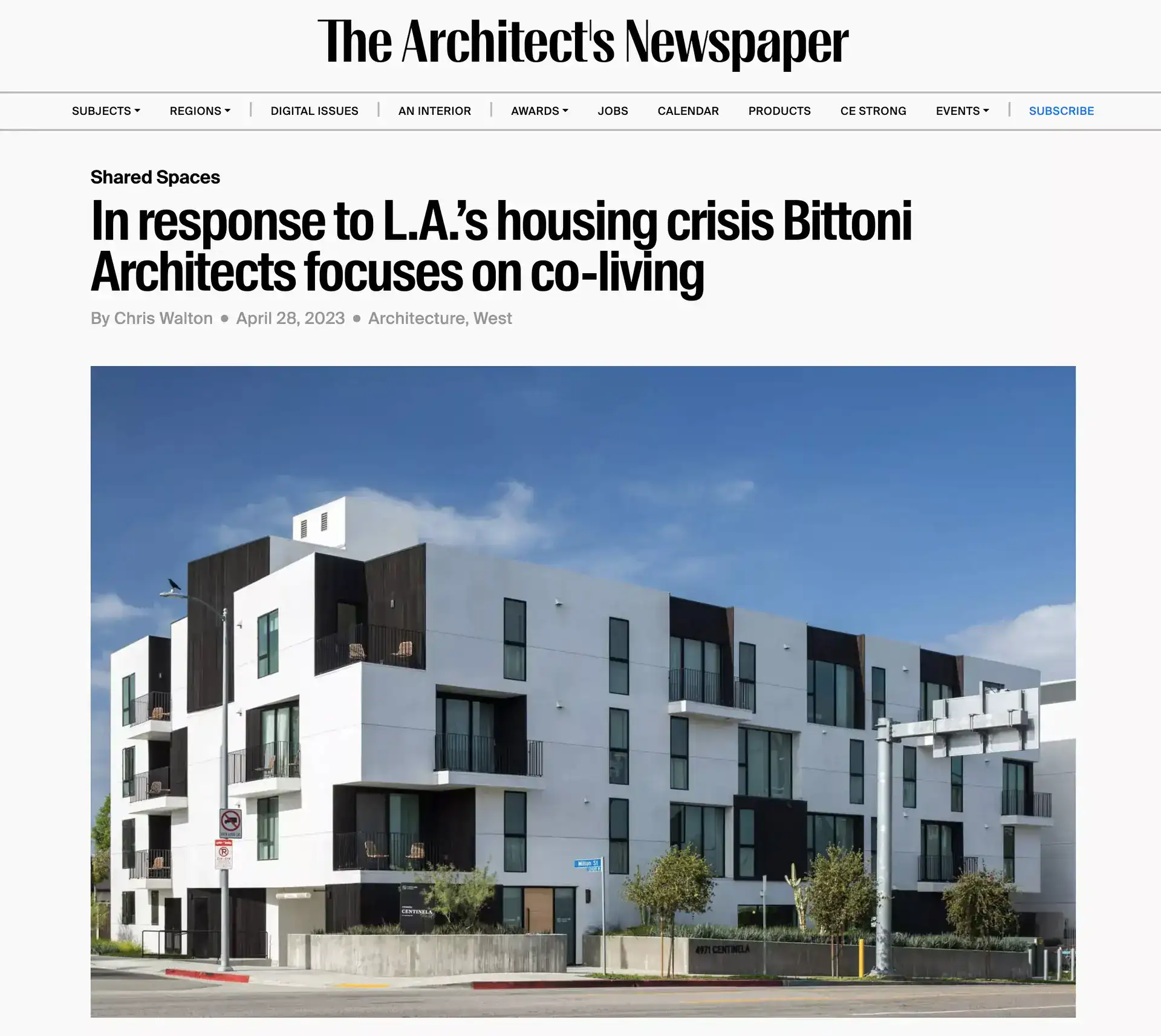Contemporary multi-family residential building with geometric forms, black and white contrasting facades, and spacious balconies.